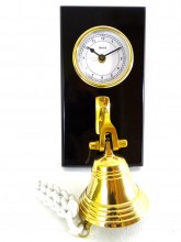 Brass clock and bell on a wooden base