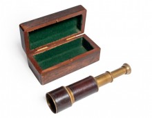 Brass and leather telescope folded in a wooden box