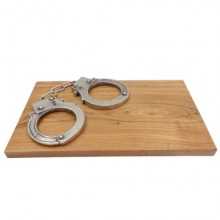 Handcuffs on a wooden support for hanging