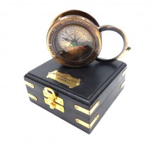 Compass with a magnifying glass in a wooden box
